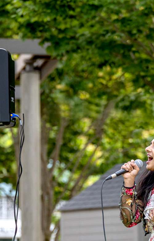Two women singing in the South Boston Maritime Park