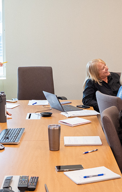 A group of people sit around a conference table