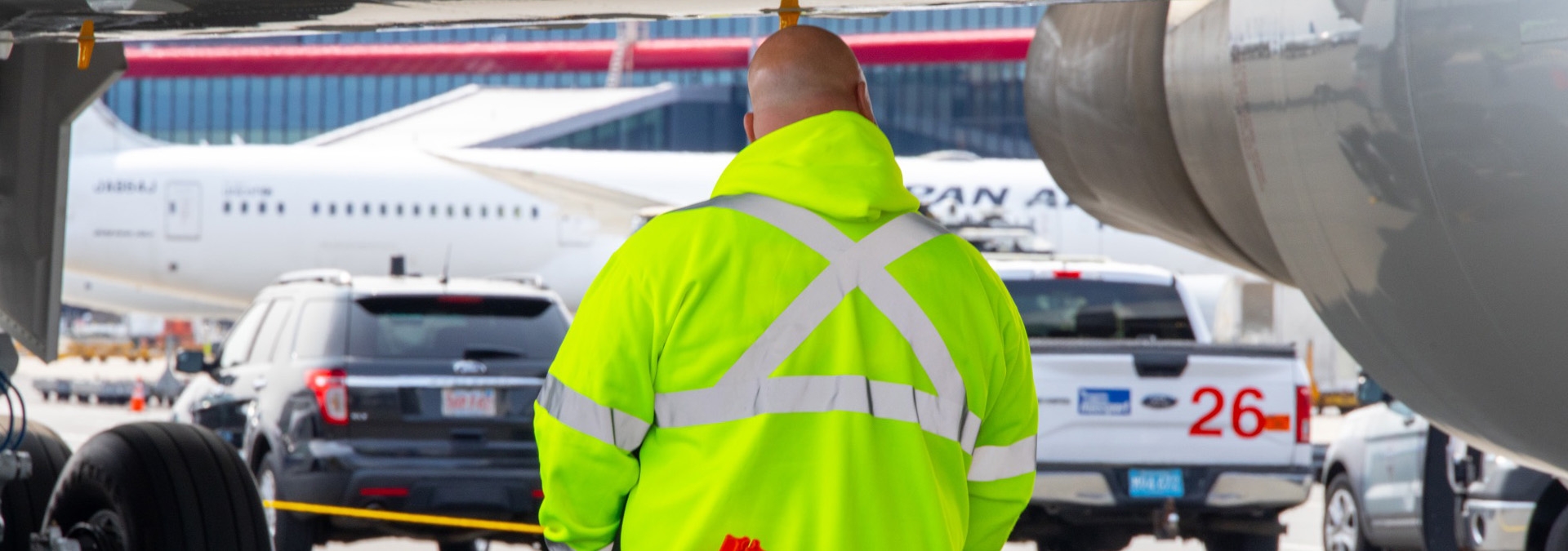 Man with a hi-visibility jacket working on tarmac
