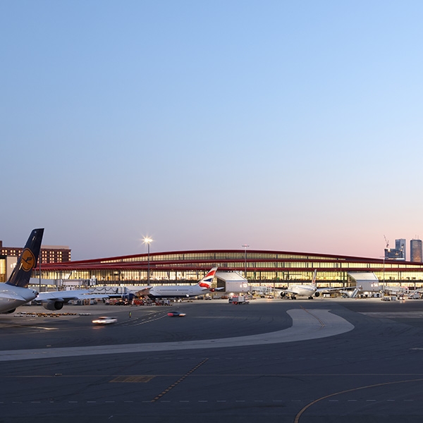 Terminal at airport with planes at gates.