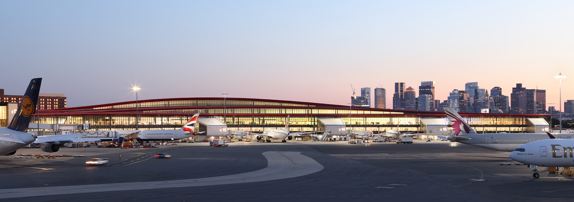 Terminal at airport with planes at gates.