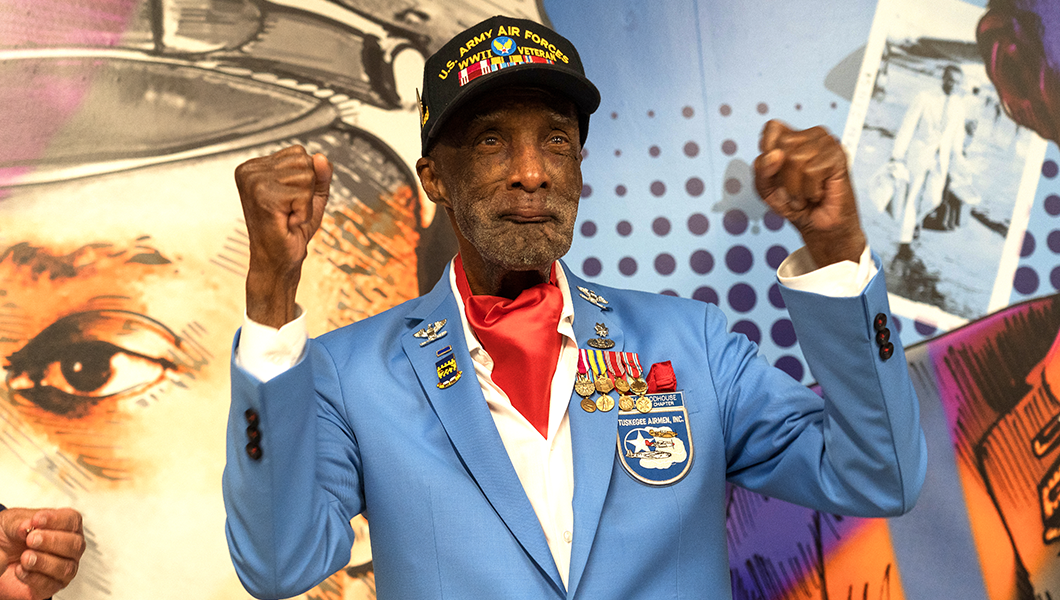 Col Lt Woody Woodhouse celebrates Tuskegee mural unveiling at Boston Logan