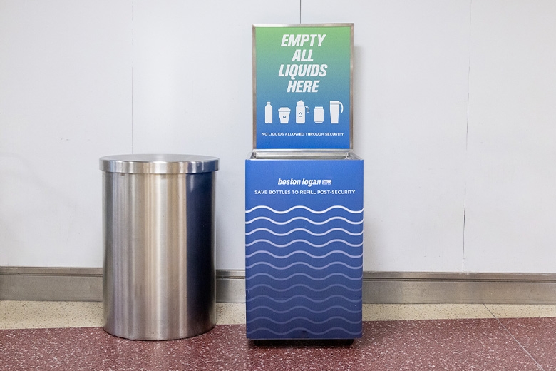 Trash bin next to a labeled liquid collection tank