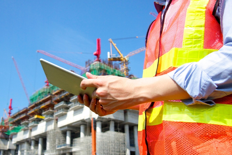 Construction worker holding tablet
