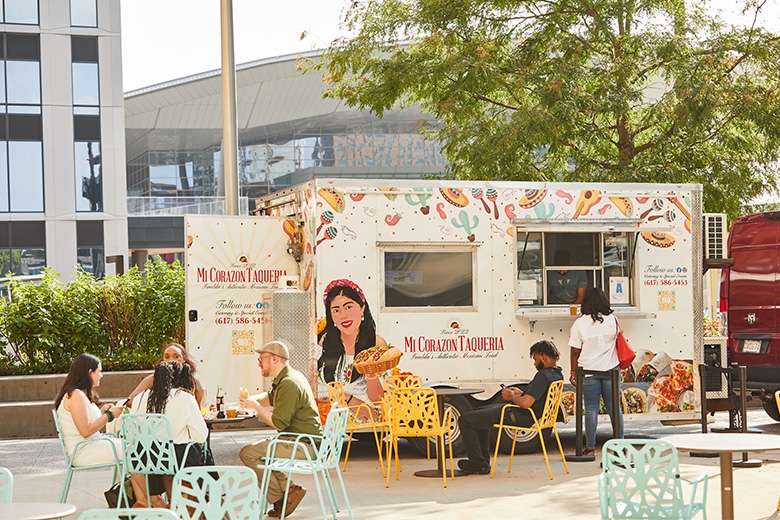 People eating outside of a food truck