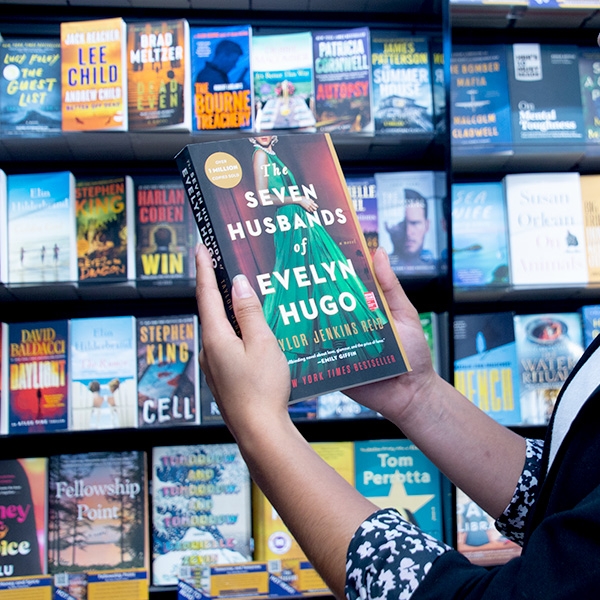 Person holding up book in bookstore