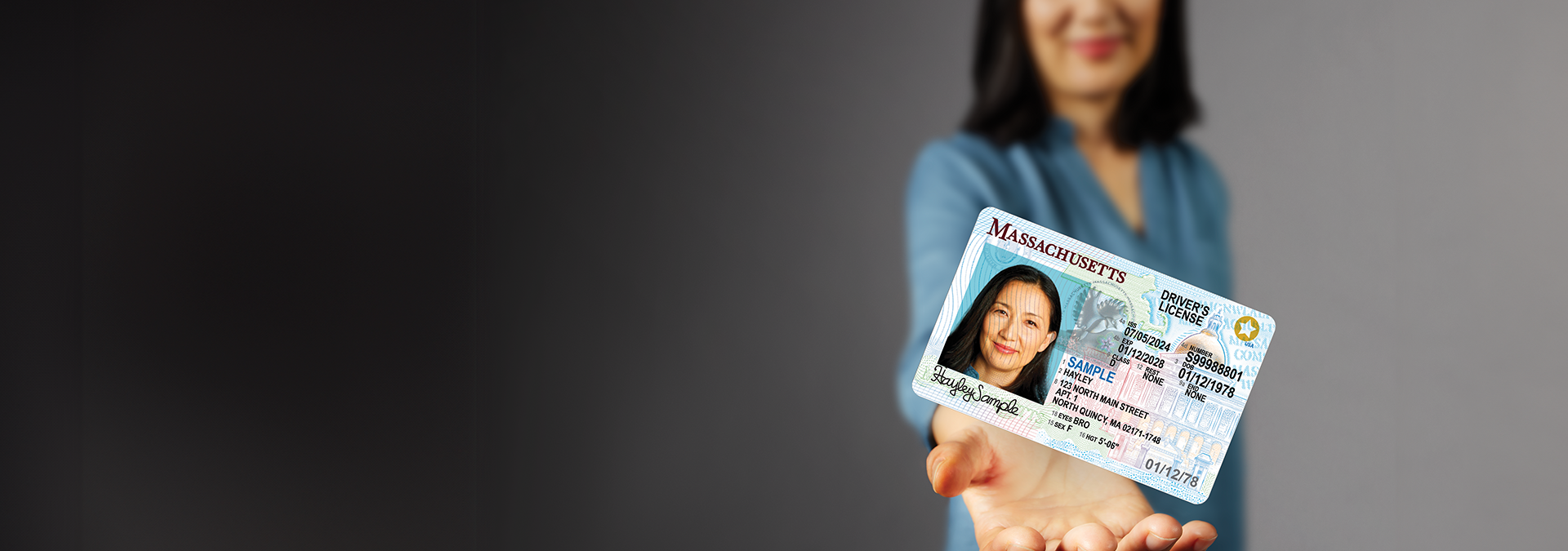 Woman holding her REAL ID