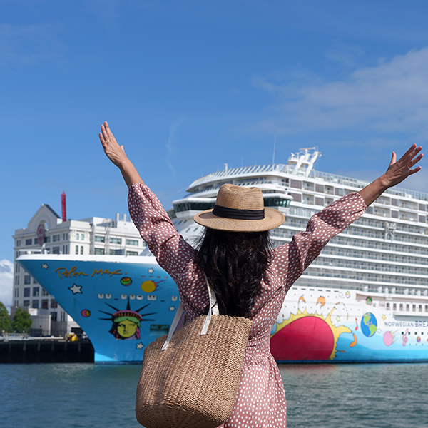 Women standing in front of cruise ship