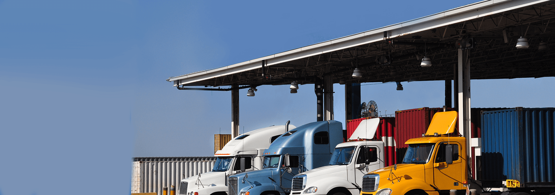 Trucks loading up cargo containers