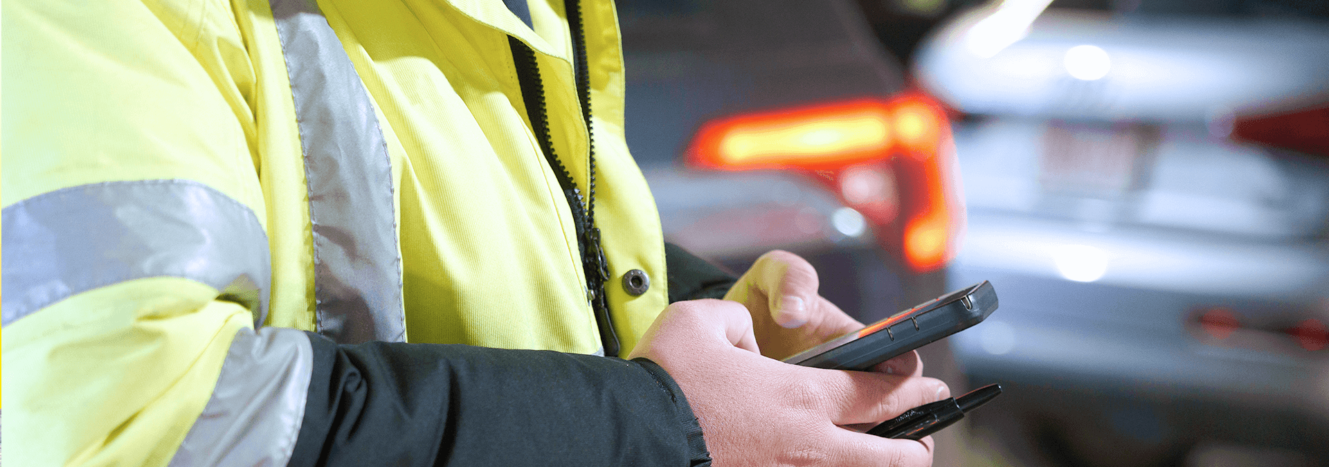 Man holding phone in parking garage