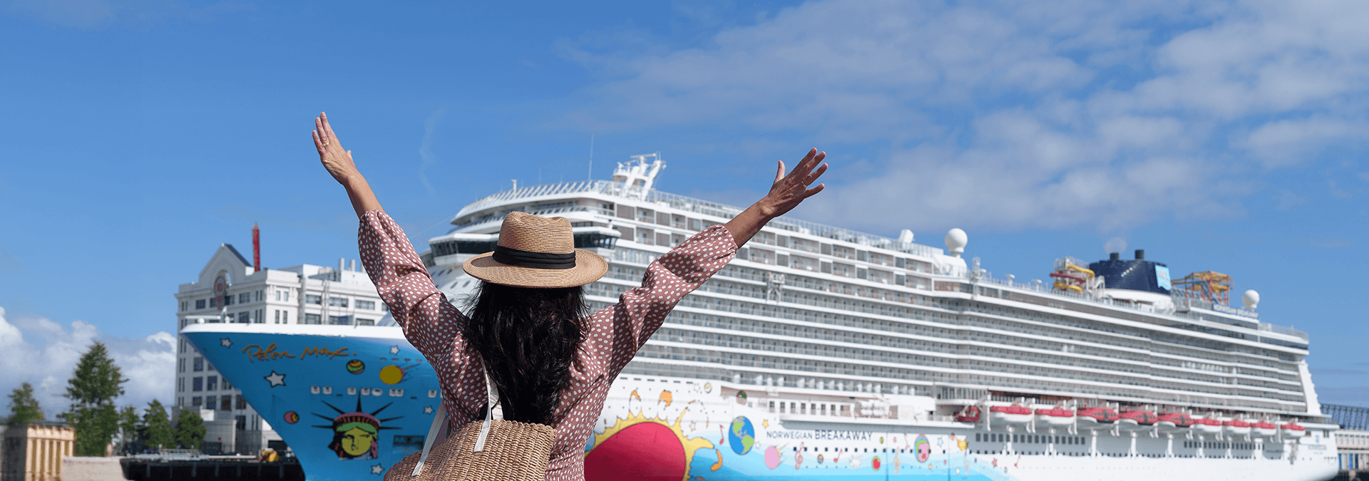 Women standing in front of cruise ship