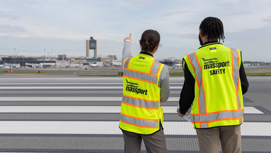 People in vests looking at airfield