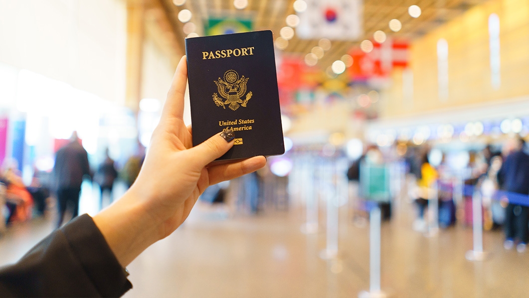 Women holding passport in Terminal E