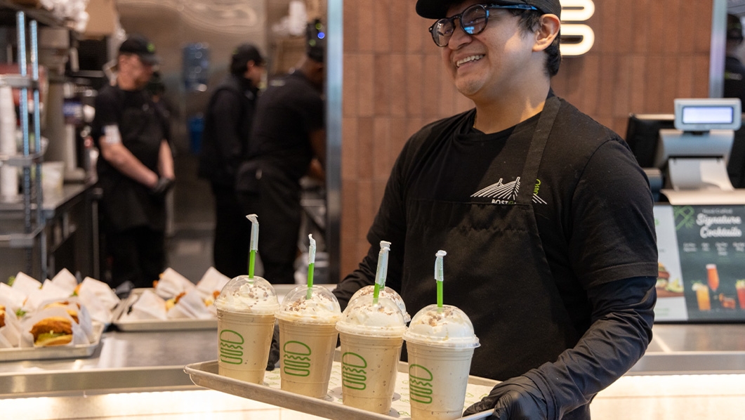 Man serving milk shakes at Shake Shack