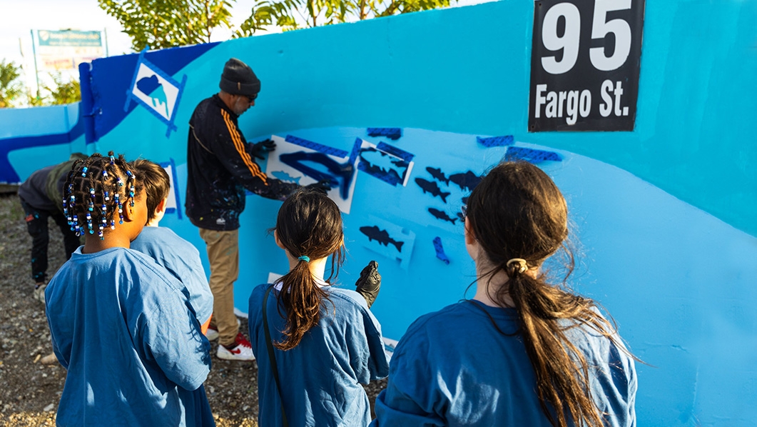 Kids painting mural at Fargo St.