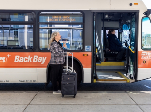 Traveler walking past Back Bay Logan Express