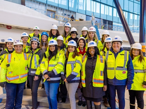 Construction workers with yellow vests and hard hats