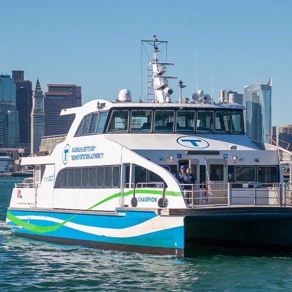 Ferry in water with city skyline in background