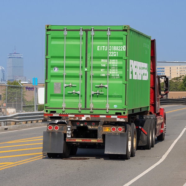 Back of a semi truck hauling a shipping container